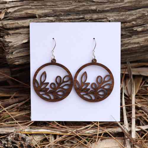 Round wooden queensland walnut earrings with intricate leaf pattern. Australian Made