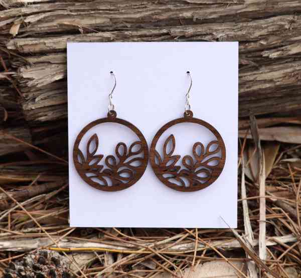 Round wooden queensland walnut earrings with intricate leaf pattern. Australian Made
