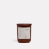 Brown candle with Wilde Aroma label, white background.