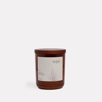 Brown candle with Wilde Aroma label, white background.