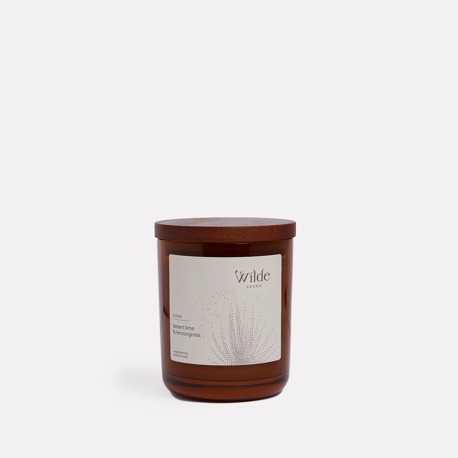 Brown candle with Wilde Aroma label, white background.