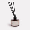 Wilde Aroma diffuser with reeds in amber bottle.