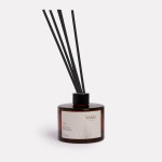 Wilde Aroma diffuser with reeds in amber bottle.