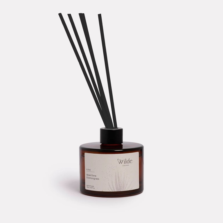 Wilde Aroma diffuser with reeds in amber bottle.