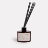 Kakadu plum diffuser with reeds in glass bottle.