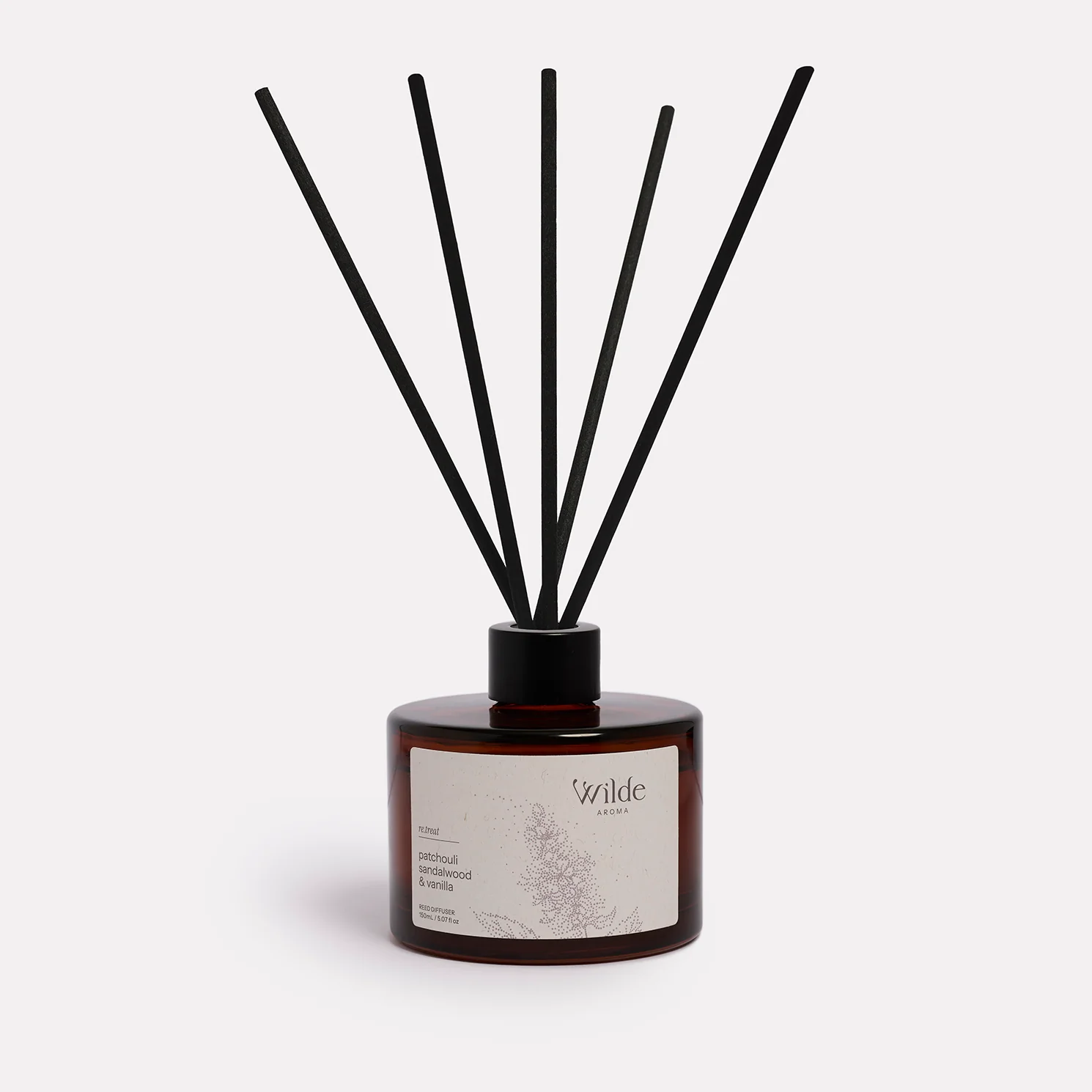 Aromatic diffuser with black reeds and elegant design.