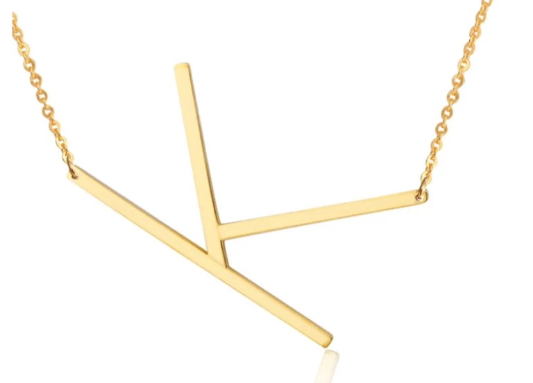 Gold abstract pendant necklace on chain.