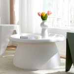 White table with vase and tulips in sunlight.