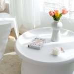 White table with flowers and book.