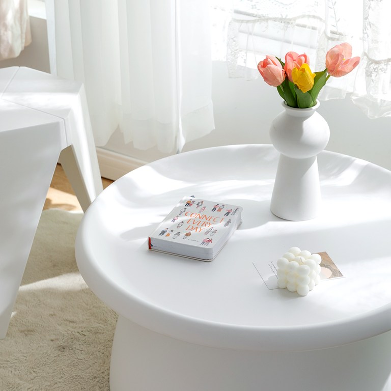 White table with flowers and book.