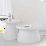 Modern white coffee tables with decor in bright room.