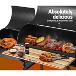grillz bbq grill 2 in 1 offset charcoal smoker Barbecue grill with assorted meats and condiments.