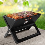 Portable BBQ with grilled meat and veggies outdoors.