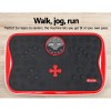Red exercise vibration plate on wooden floor.