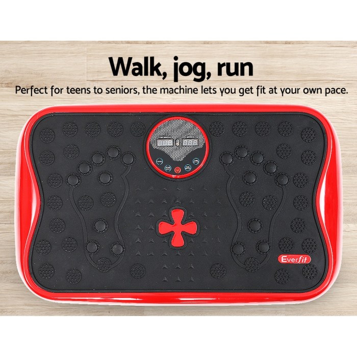 Red exercise vibration plate on wooden floor.