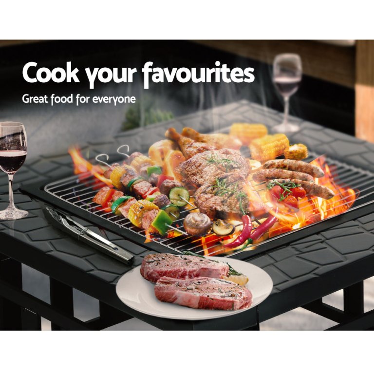 Barbecue with meats, vegetables, and wine glasses.