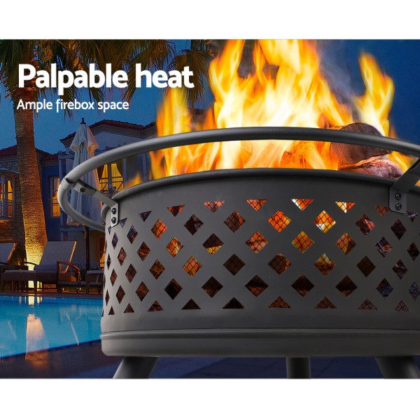 Outdoor fire pit with flames at night.
