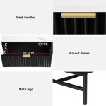 Modern table with drawer, sleek handles, metal legs.
