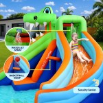 Child sliding on inflatable water slide with features.