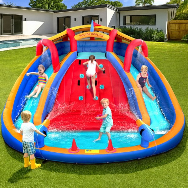 Kids playing on inflatable water slide, backyard fun.