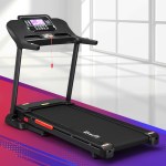 Modern black treadmill in bright room