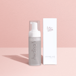 Legend Age skincare bottle and box on pink background.
