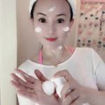 Woman applying facial foam skincare product