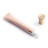 Luxury skincare cream tube with golden cap.