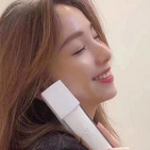 emulsion spray | triple action | super moisturizing | acne & spot removal Smiling woman holding white skincare product.