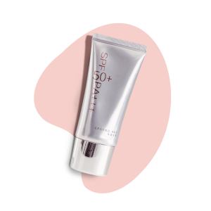 Legend Age SPF 50+ sunscreen tube on pink background.