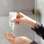 Applying SPF 50+ sunscreen to hands.