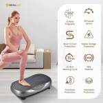 Woman exercising on vibration platform in living room.