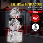 Christmas gift box stack with LED lights indoors.
