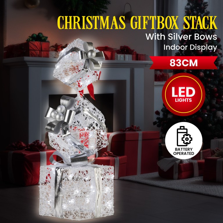 Christmas gift box stack with LED lights indoors.