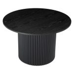 Round black textured dining table with ribbed base.