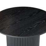 Round black wood grain table top close-up.