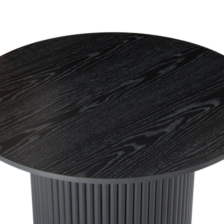 Round black wood grain table top close-up.