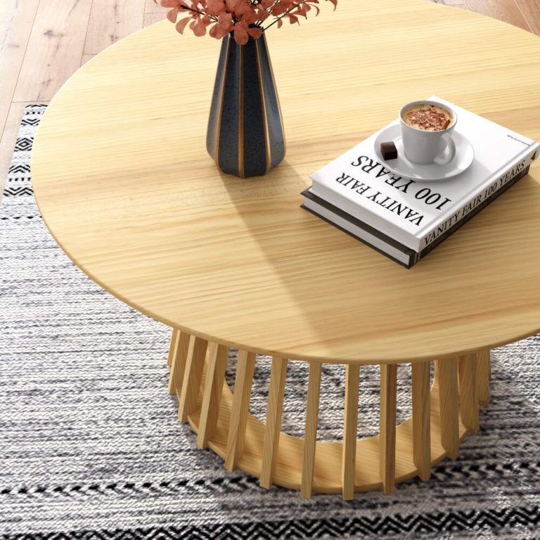 palmer coastal haven natural coffee table Round wooden table with coffee and books.