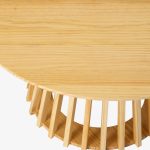 palmer coastal haven natural coffee table Round wooden table with unique base design.