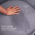 Hand touching grey velvet chair with removable cover.