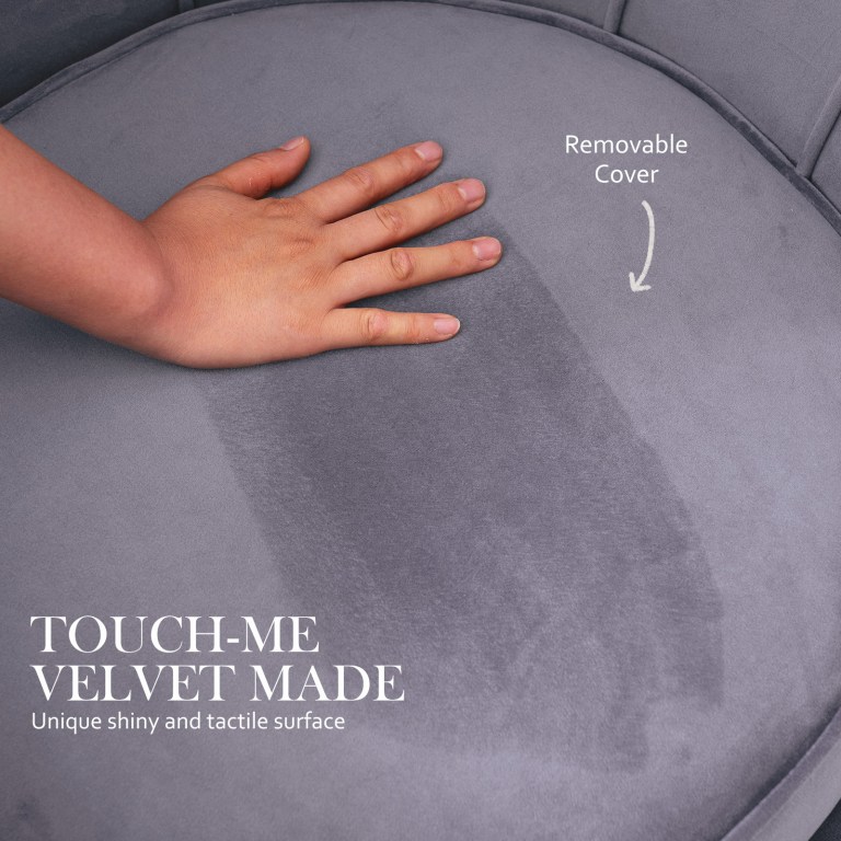 Hand touching grey velvet chair with removable cover.