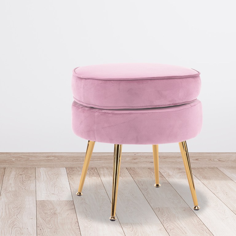 ottoman foot stool velvet fabric metal leg round pink Pink velvet stool with gold legs on wooden floor.