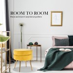 ottoman foot stool velvet fabric metal leg round yellow Modern bedroom with yellow ottoman and decorative items.