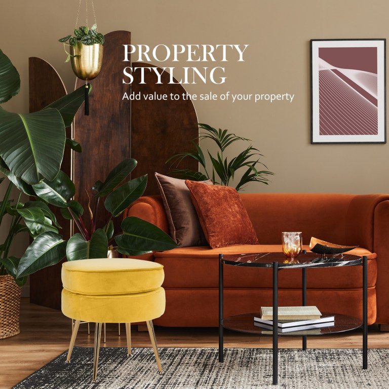 ottoman foot stool velvet fabric metal leg round yellow Stylish living room with sofa and plants.