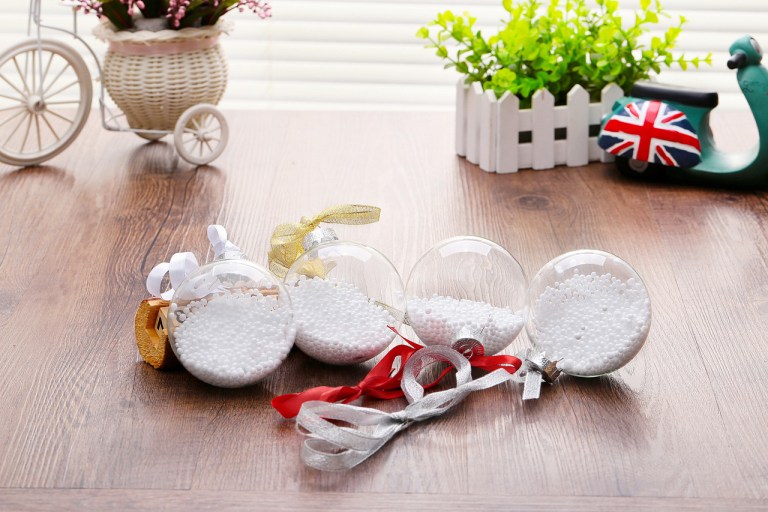 Decorative ornaments with ribbons on wooden table.