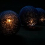 Glowing orbs in dark setting, warm ambient lighting.