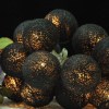 1 set of 20 led black 5cm cotton ball battery powered string lights christmas gift home wedding party bedroom decoration outdoor indoor table centrepiece Illuminated black string lights next to purple flowers.