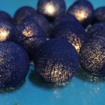 Purple textured balls on blue surface, close-up view.