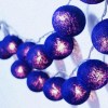 String of purple decorative lights glowing indoors
