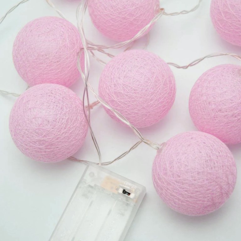 v382 palepinkballbatt20 202504030820 00.jpg Pink cotton ball string lights on white background.